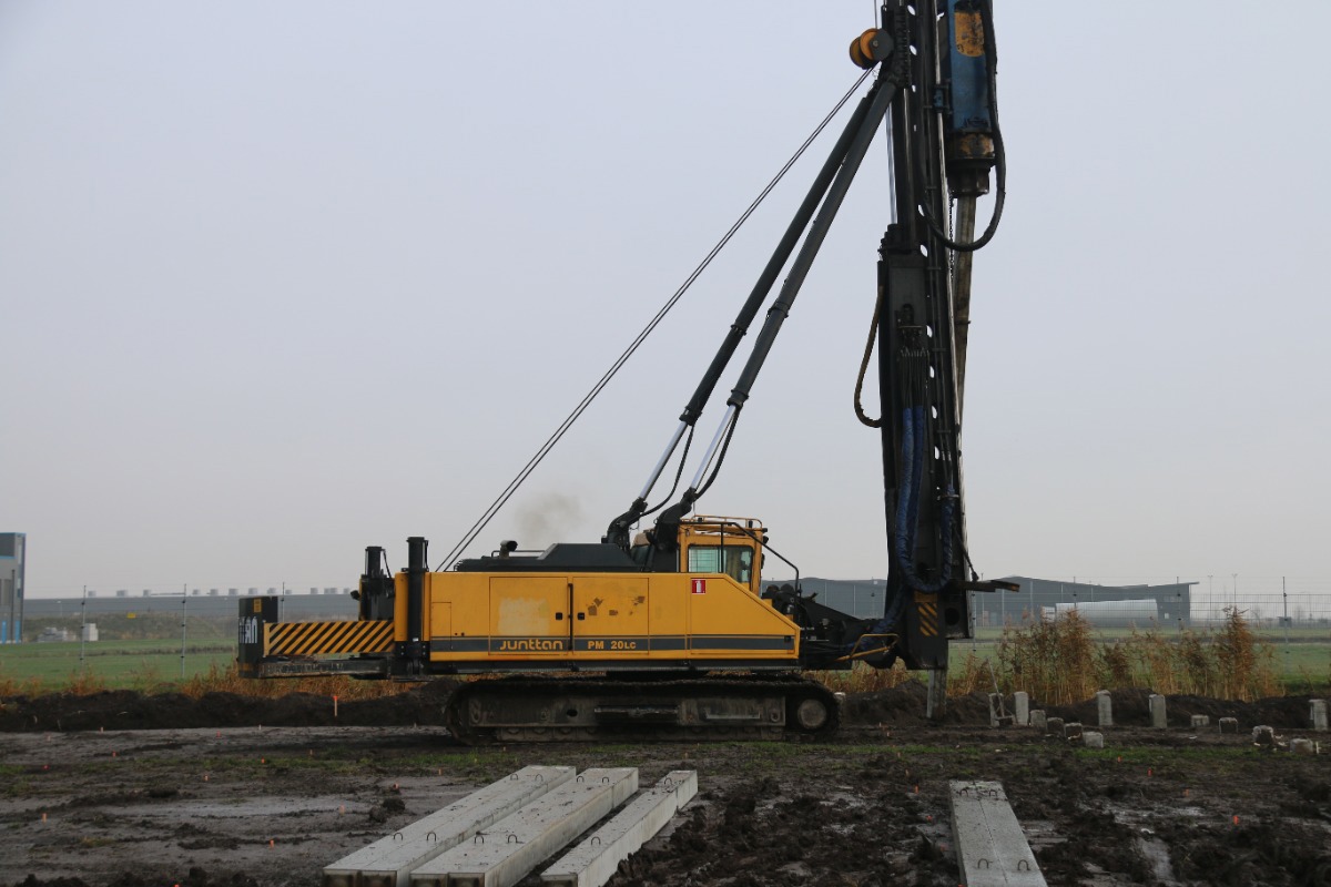 Construction pile driving at building site